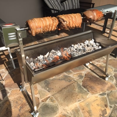 BBQ spit rotisserie cooking 3 roast meats over charcoal