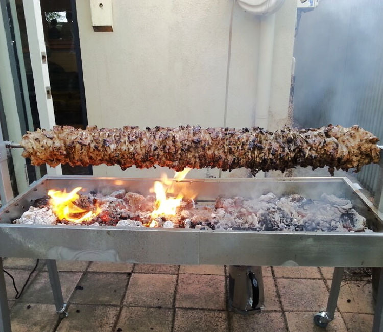 A spit roaster with a full kebab style meat showcasing the guide "Spit Roasters | A Comprehensive Guide"
