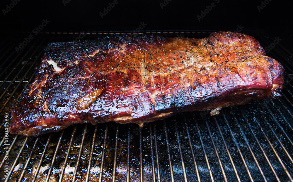 Portable Pellet Smoker, three views with smoker sitting on table, and lid open with food cooking