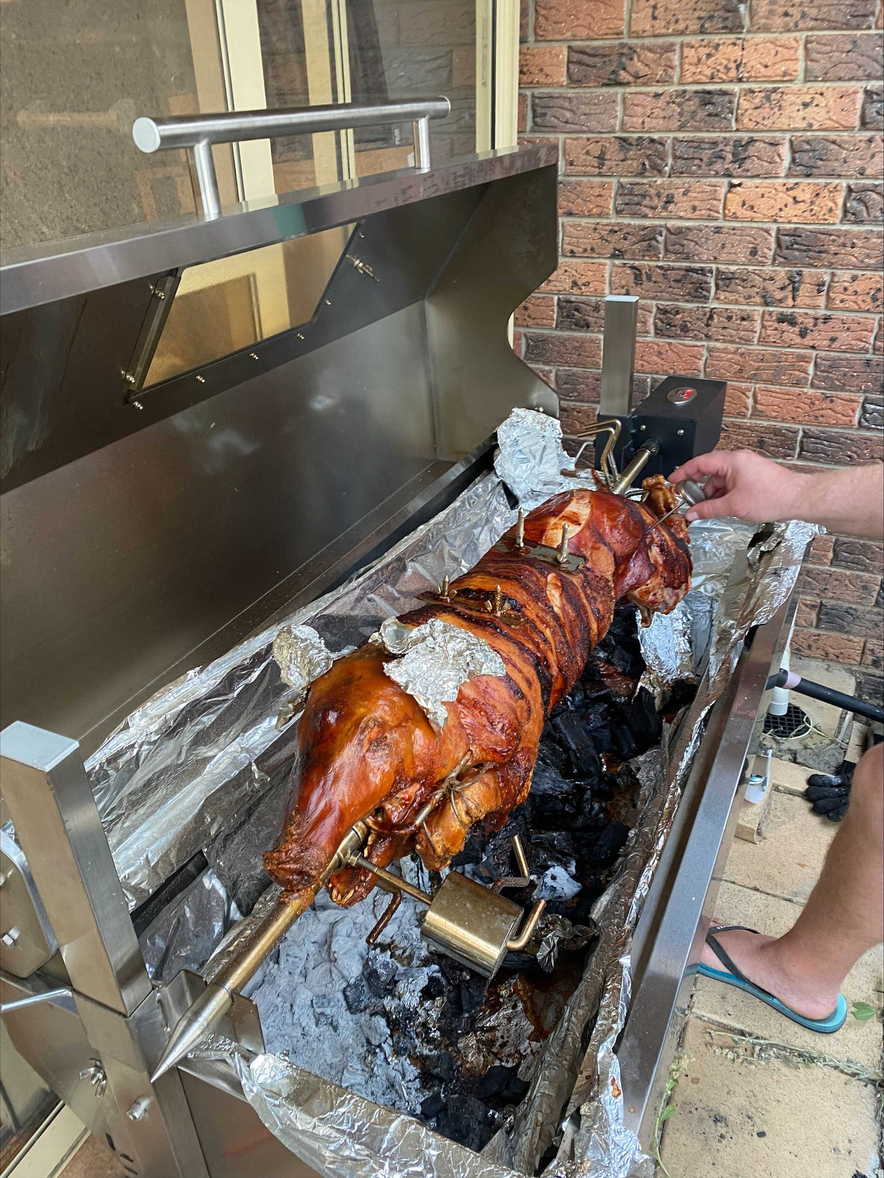 1200mm spartan spit roaster with a whole pig cooking on it