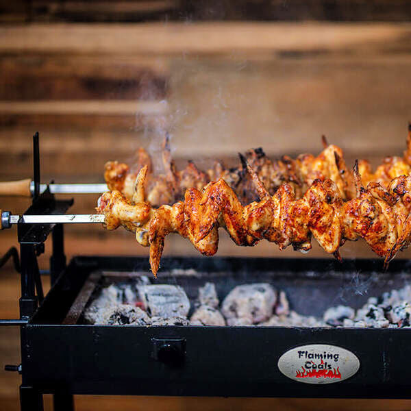 BBQ Spit Roaster | Cyprus | Flaming Coals showing meat cooking with no spit attached