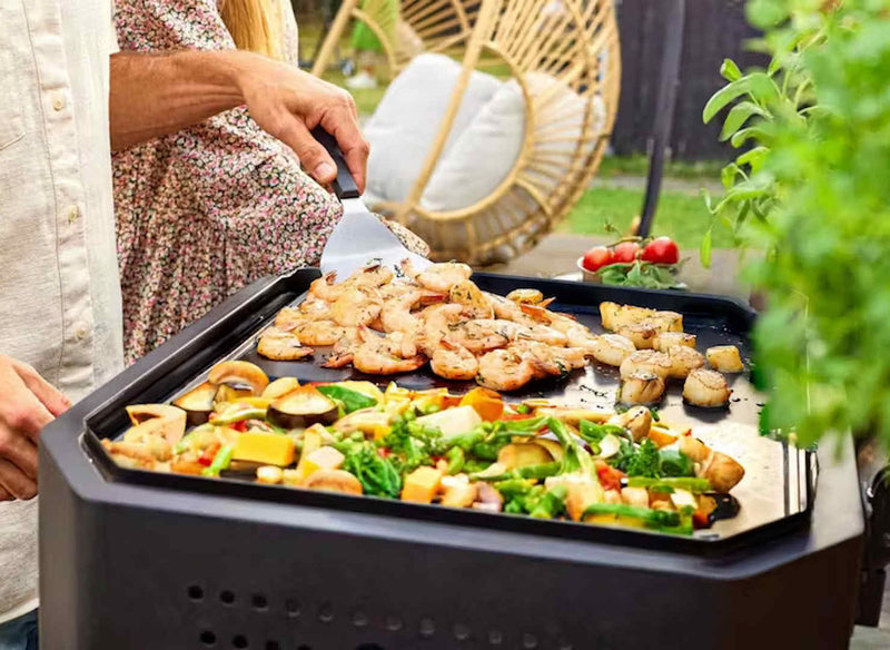 Cozze B-500 Gas BBQ guy cooking seafood and veggies on griddle