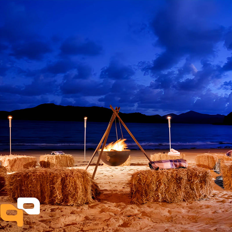 Tripod Fire Pit on beach with roaring fire inside