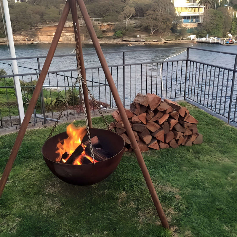 Tripod Fire Pit top view with fire inside and canal in background