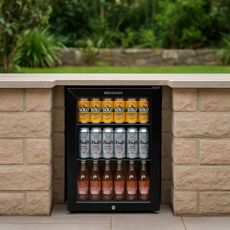 Schmick 70 L Black Double-Glazed Bar Fridge – Right or Left Hinge - HUS-SC70-B built into an outdoor area full of drinks