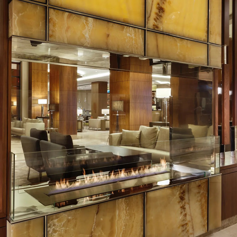 FLA4 BEV Bio Ethanol Fireplace Insert | Indoor shwoing a unit in a reception with glass panels