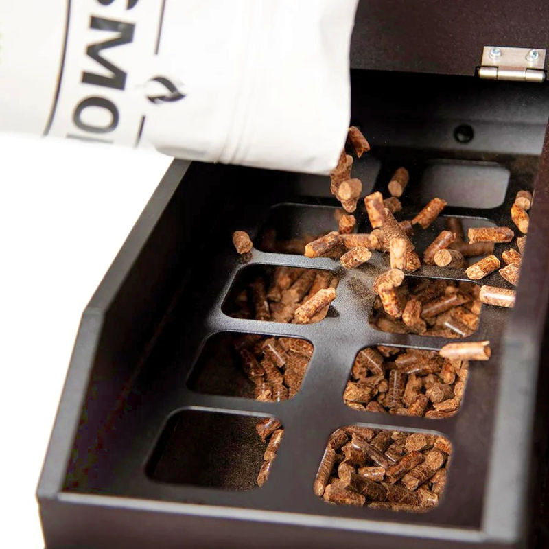 Close up view of pellets being poured into hopper