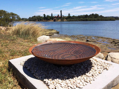 Outdoor Fire Pit: the cauldron hearth with BBQ Grill near the ocean
