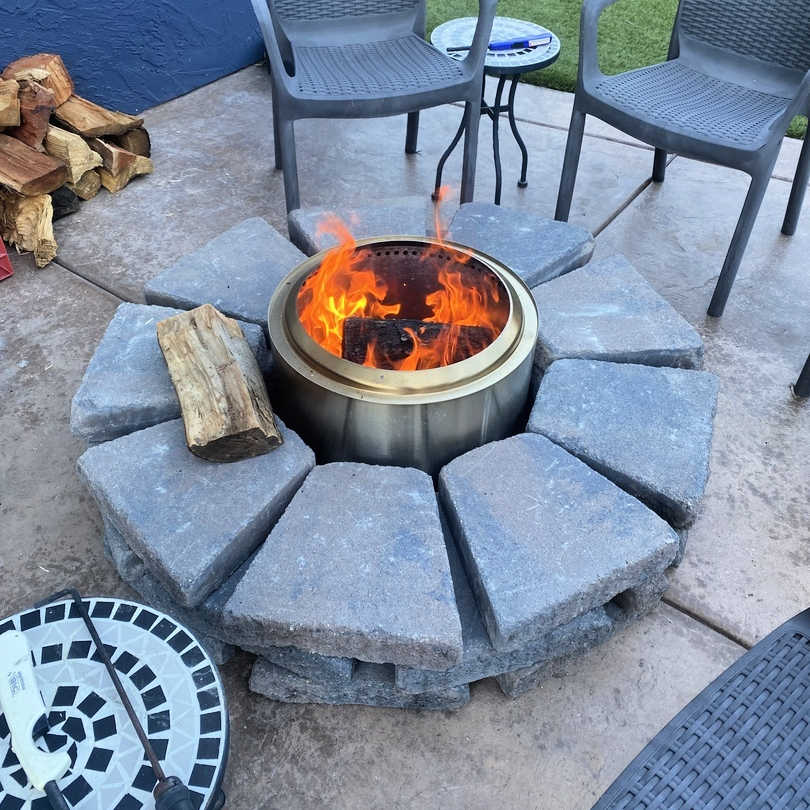 Smokeless fire pit in a built in setting with seating around it by outdoor living australia