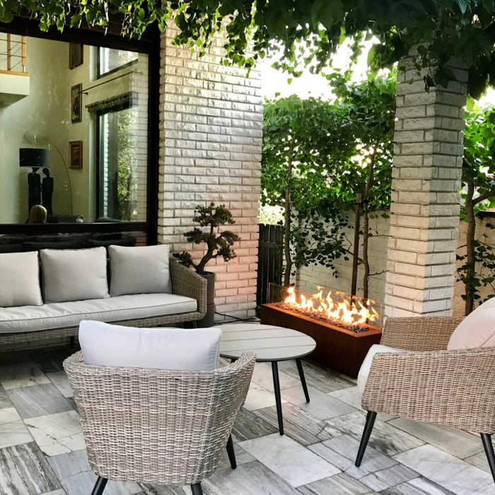 outdoor gas fire pit in an outdoor setting with outdoor furniture
