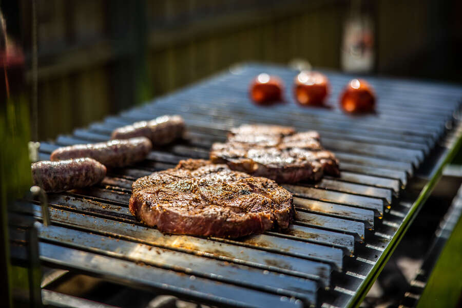 Sausages and Steaks grilling on the Parrilla BBQ