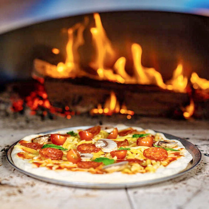Pizza Recipe | cooked pizza sitting inside wood fired pizza oven