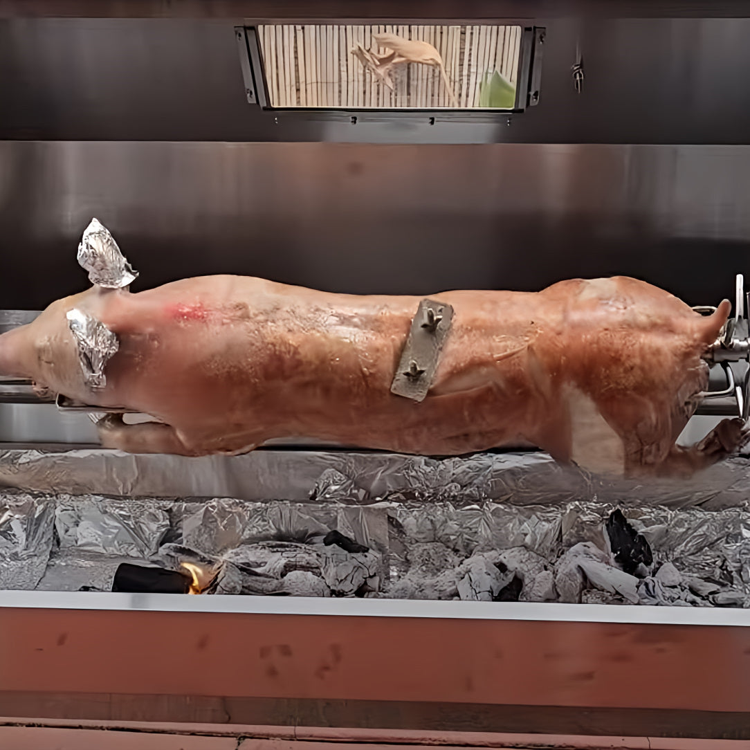 A whole pig on a spit using a 1500 spartan hooded charcoal spit rotisserie