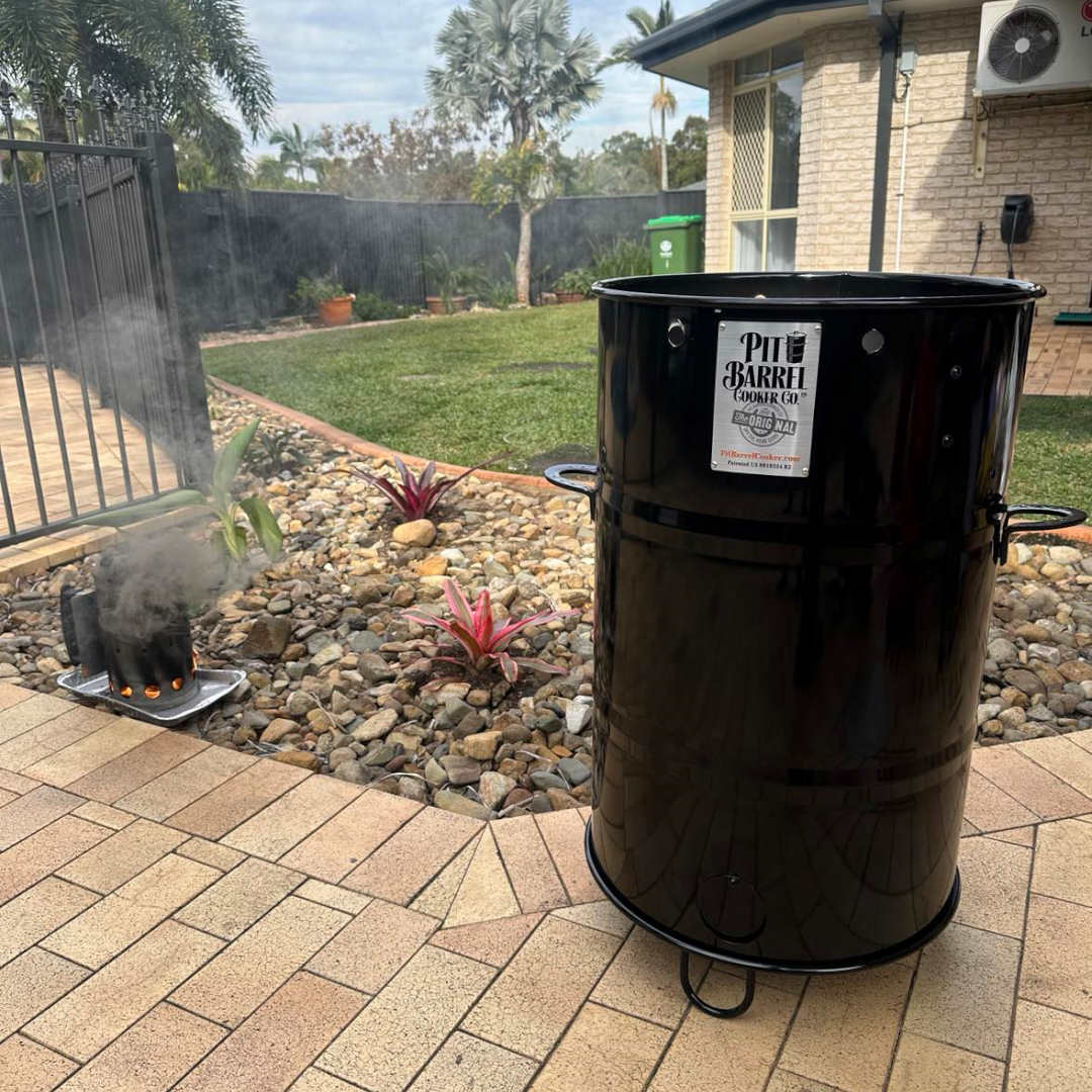 Pit Barrel Cooker and Smoker in backyard smoking meat