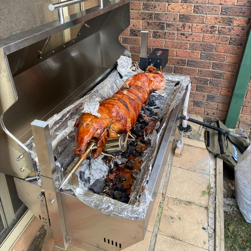1200 mm Hooded Spartan BBQ Spit Roaster Rotisserie side view with a full cooked pig
