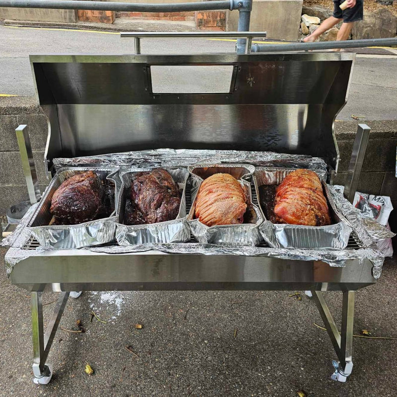 1200 mm Hooded Spartan BBQ Spit Roaster Rotisserie showing meats being cooked in an oven style with the hood open at the end of the cook