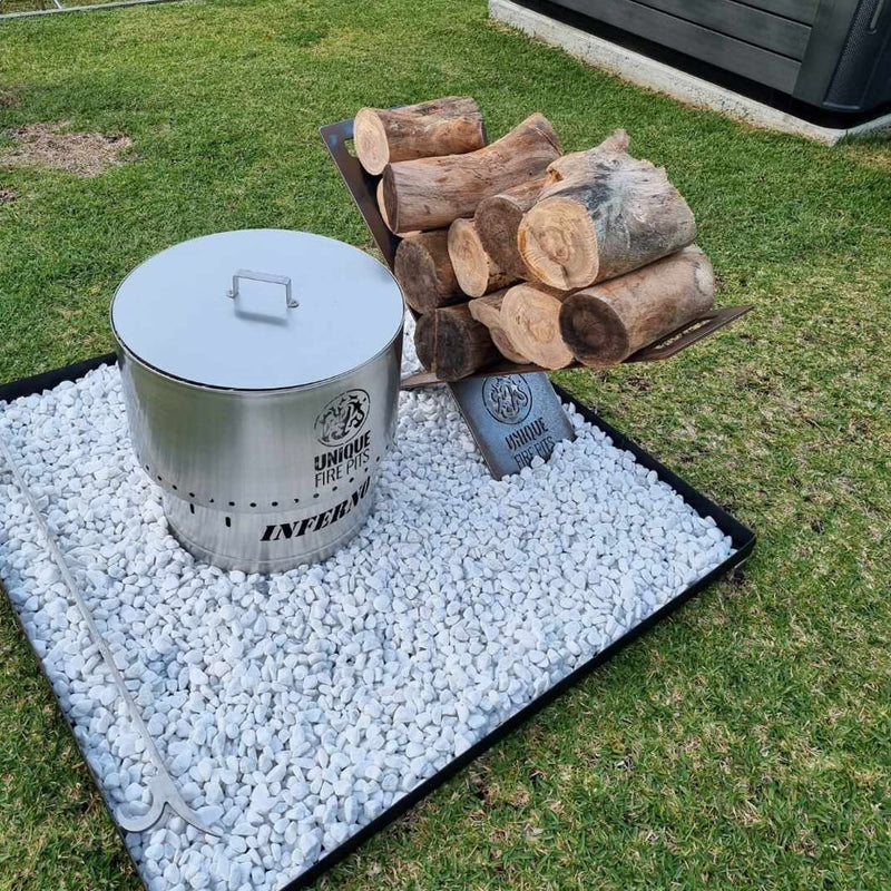 Smokeless Fire Pit With FREE Grill, Lid and Carry Bag showing the 650 mm next to log in backyard