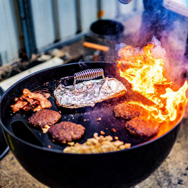 Cast Iron Burger Press | sitting on a bbq wrapped in alfoil with burgers ready to be pressed
