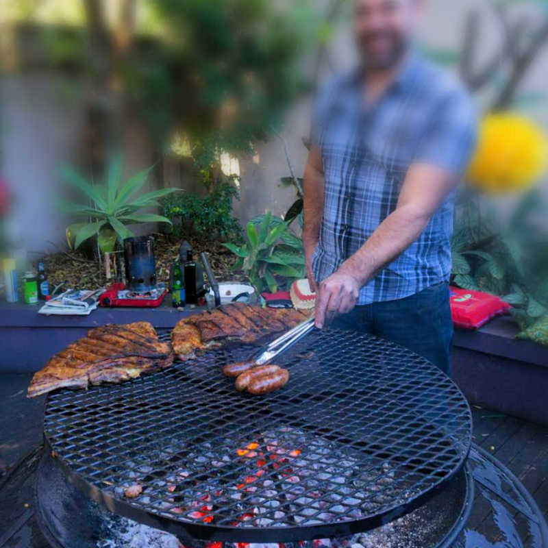 BBQ Grill and Fire Pit close up view of grill with meat cooking