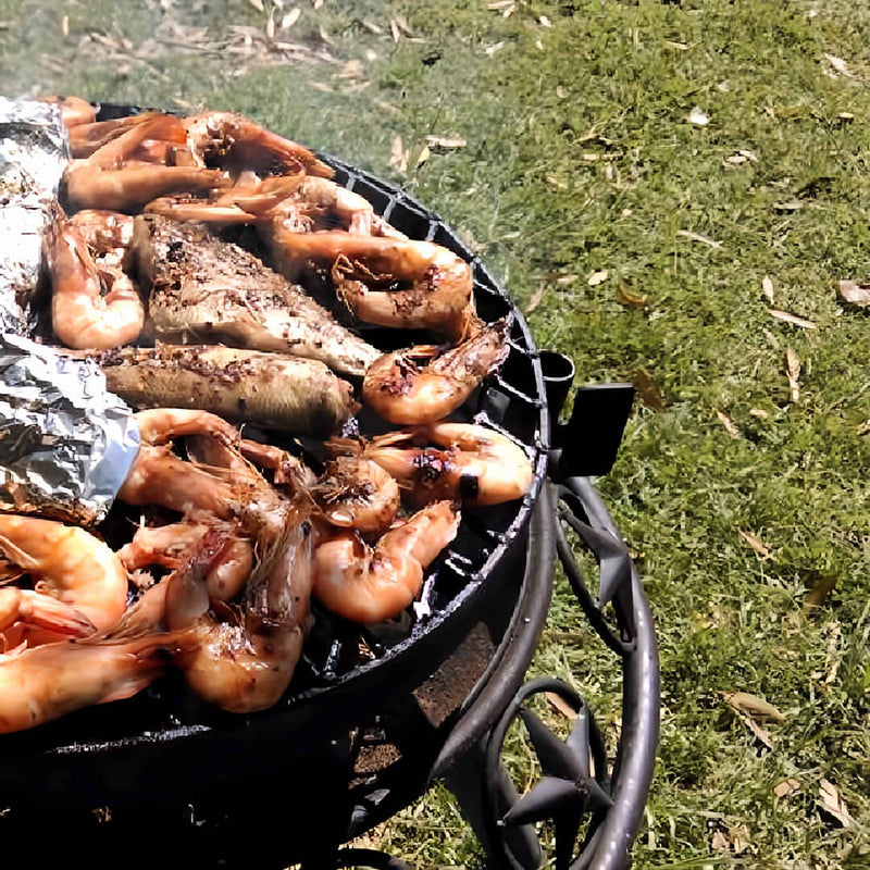 BBQ Grill and Fire Pit  close up view of cooking prawns on star design 