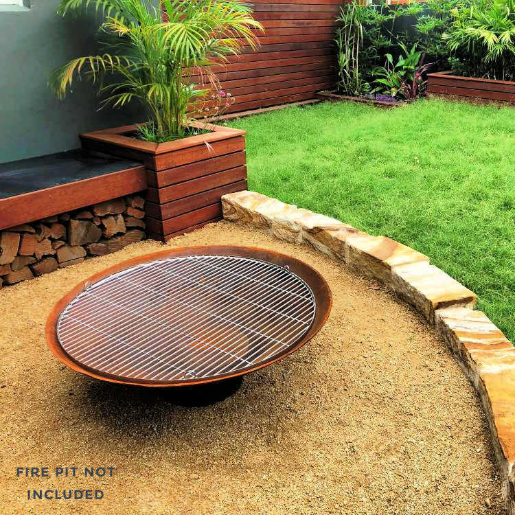 BBQ grill for fire pits in stainless steel  by outdoor living australia top view of it sitting on a fire pit