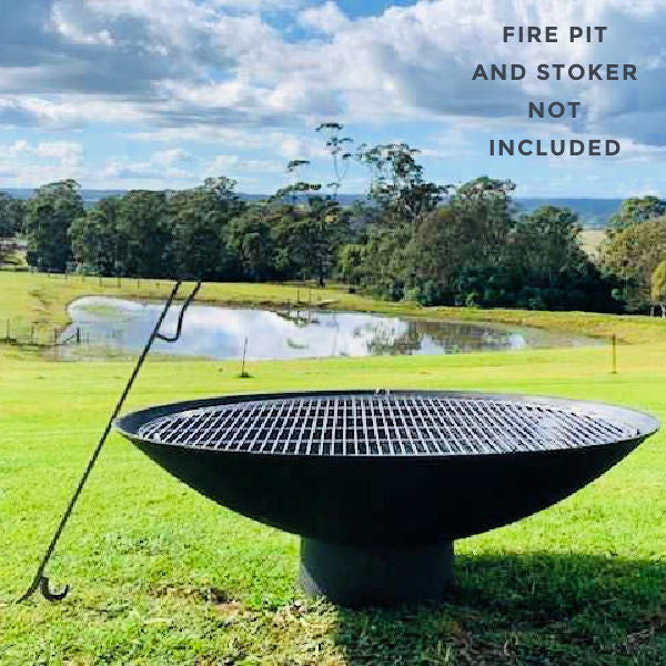 BBQ grill for fire pits in stainless steel  by outdoor living australia on a fire pit with a  fire poker | stoker next to it