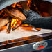Heat Resistant Gloves | showing how to put wood into a pizza oven with gloves on