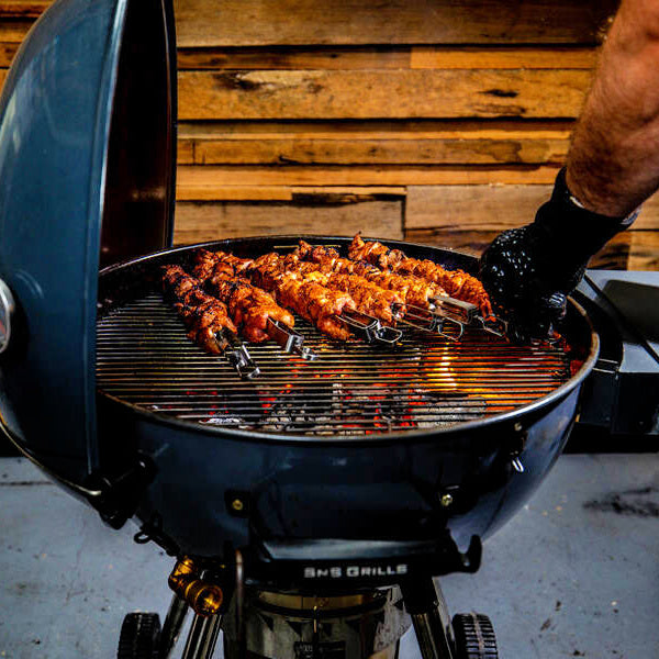 Heat Resistant Gloves | another view of man handling kebabs with gloves on