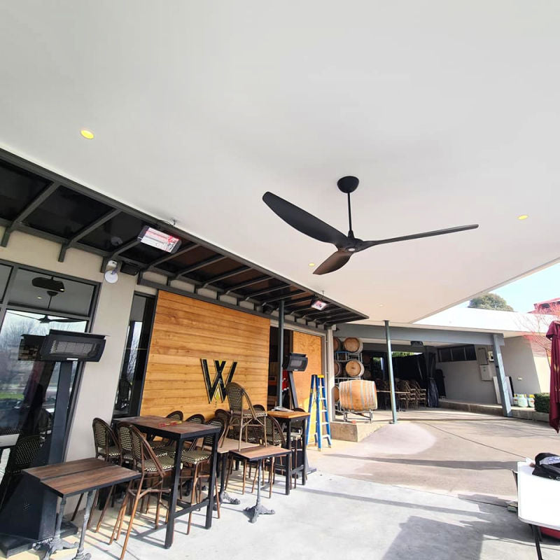Infrared Heater | Outdoor | Electric | Heliosa 66 outside a cafe area iwth a fan showing