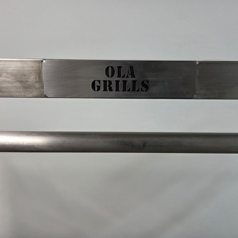 Parrilla Argentine BBQ with Firebricks | 100% 304 Stainless | South American Style Cooking showing a close up fo the OLA Grills Tag
