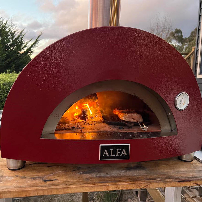 Pizza Oven | Alfa Nano | Wood or Gas close up view with fire inside and cooking steak
