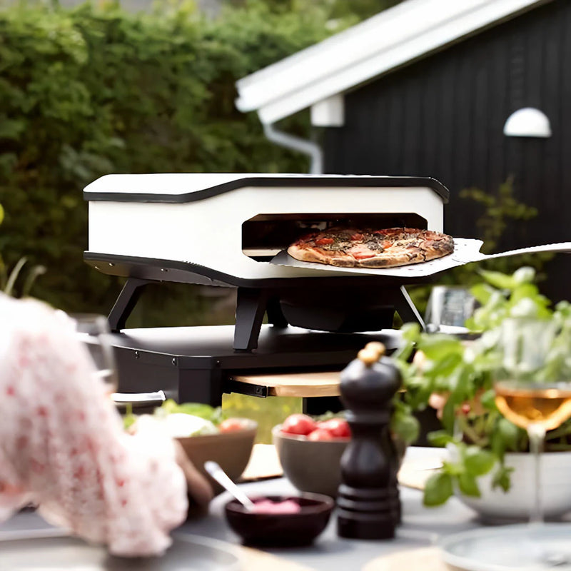 Cozze 13" ELECTRIC Pizza Oven Bundles | Choose From 4 Different Packs showing the unit in use in a backyard