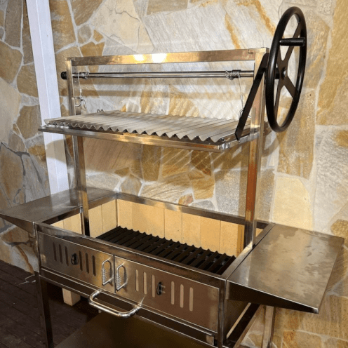A parrilla charcoal BBQ grill with the grill at the highest point