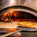 Stainless Steel Log Holder | in pizza oven with fire on holder and pizza cooking
