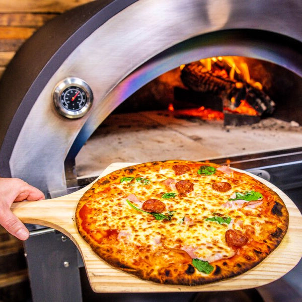 Wooden Pizza Peel | view of peel with a perfectly cooked pizza on it