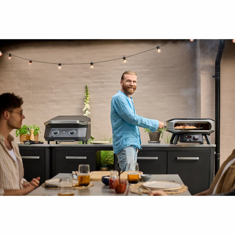 Pizza Oven Premium Rotate Electric 13″ & 17″ — Rotating Stone showing someone using it