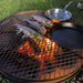 Outdoor Fire Pit Bundle | Cauldron Hearth with Grill | Cast Iron with fish cooking and some frying pans on top showing full size