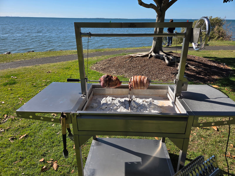Parrilla Argentine BBQ with Firebricks | 100% 304 Stainless | South American Style Cooking showing the rotisserie with meat cooking