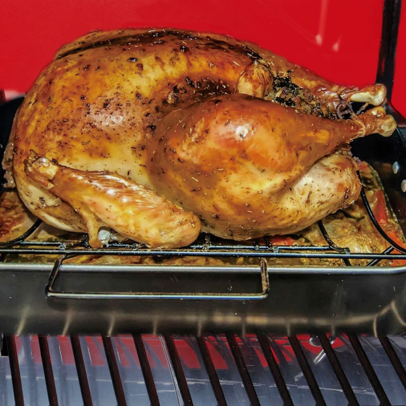 view off a smoked chicken cooking on the smoker