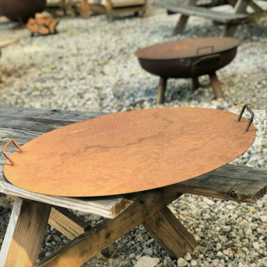 Fire Pit Accessory: Fire Pit Lid in cast iron resting on table