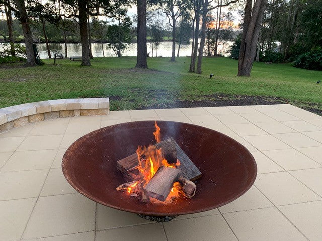 Outdoor Fire Pit: the cauldron hearth with BBQ Grill showing the fire pit with fire lit