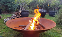 Outdoor Fire Pit: the cauldron hearth with BBQ Grill close up with fire lit