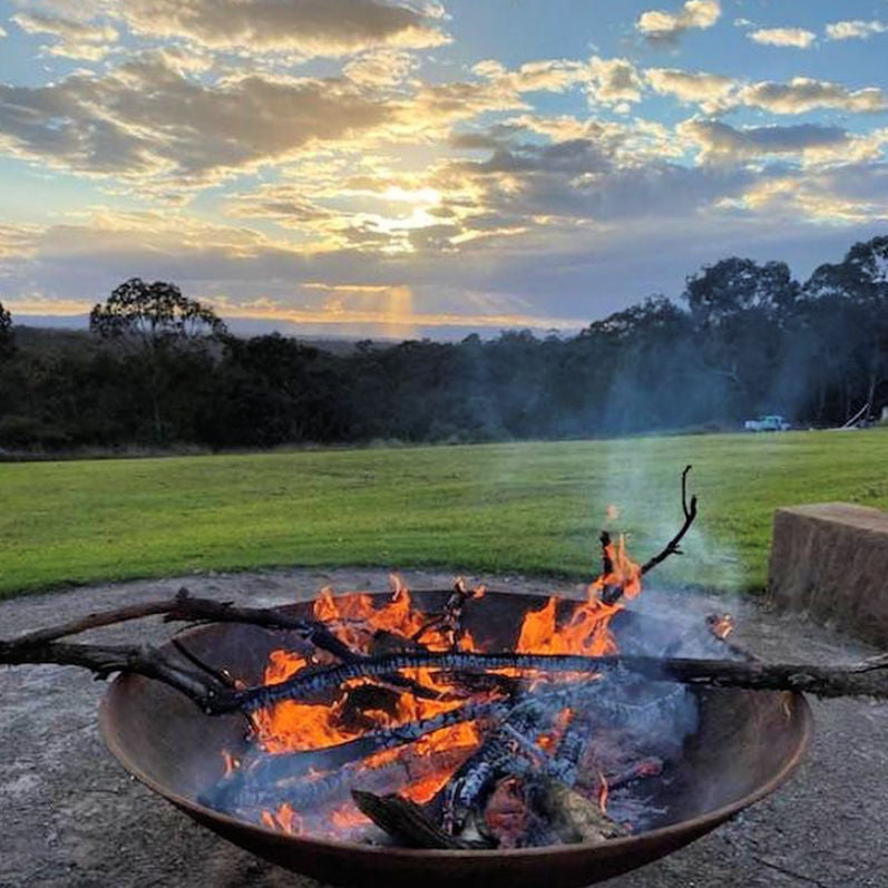 Fire Pit: Mega Cauldron lit with sunset in background