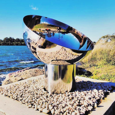 Fire Pit: The Goblet Of Fire in stainless steel side view near water