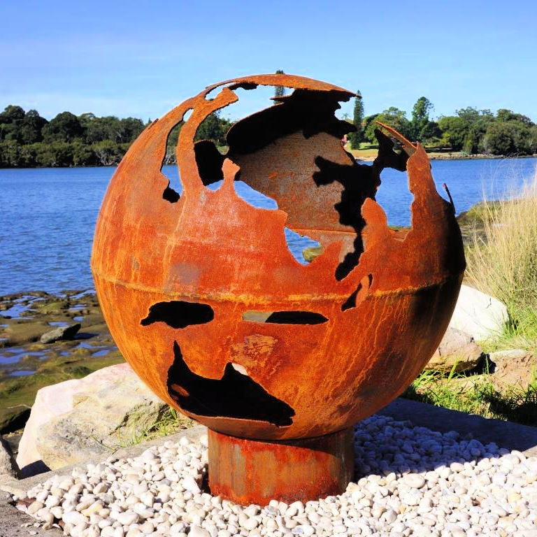 Fire Pit: World Globe near a lake