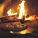 Flaming Coals: Wood Fired Pizza Oven fire with pizza inside
